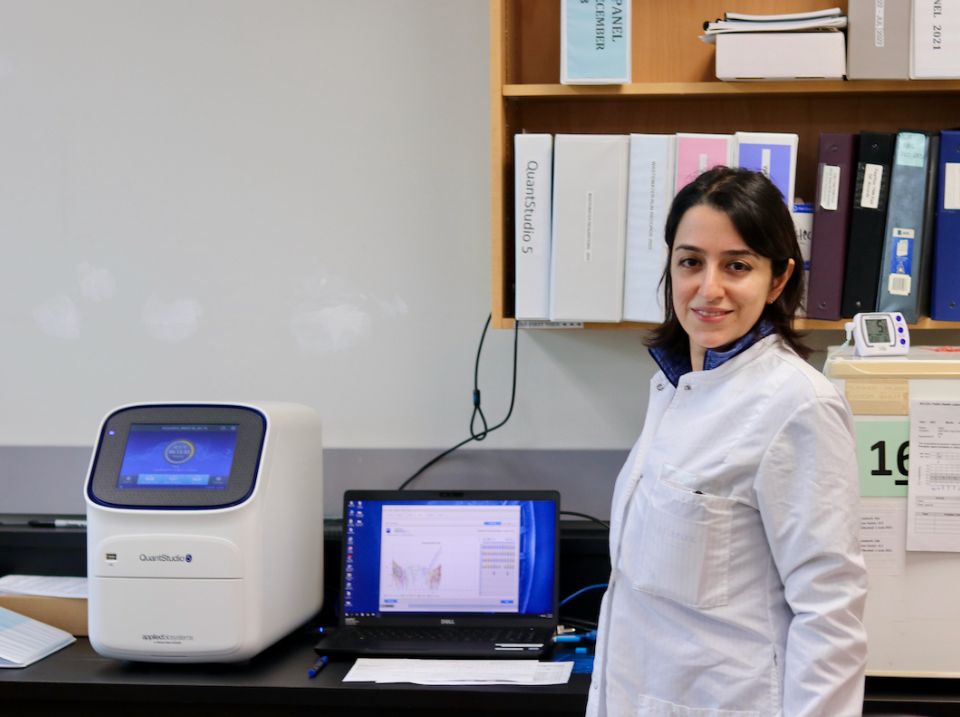 BCCDC Public Health Laboratory employees next to a machine for whole genome sequencing