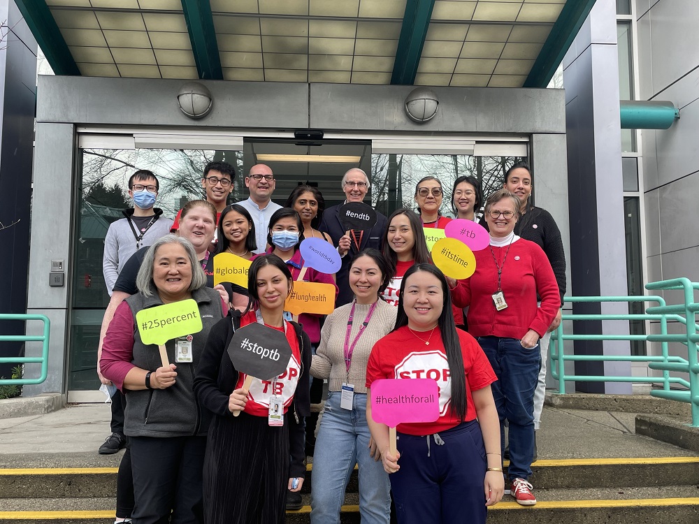 Members of the BCCDC TB Services team at the Vancouver clinic stand outside holding signs calling to #endtb