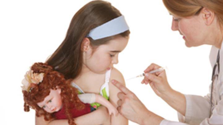 Nurse immunizing girl