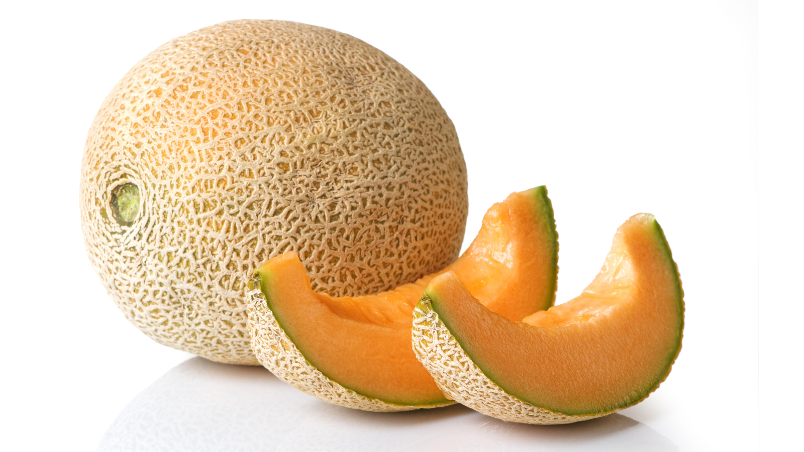 Two slices of cantaloupe sit next to a whole cantaloupe