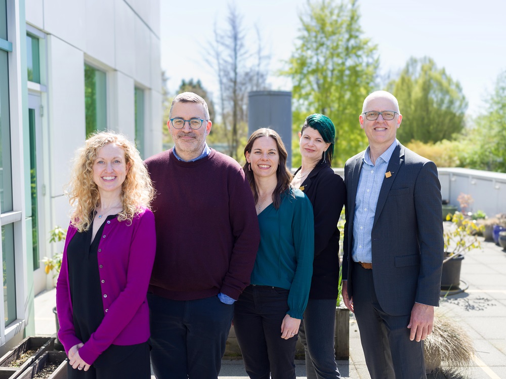 Leaders of the GetCheckedOnline team stand on a patio outside the BC Centre for Disease Control office in Vancouver